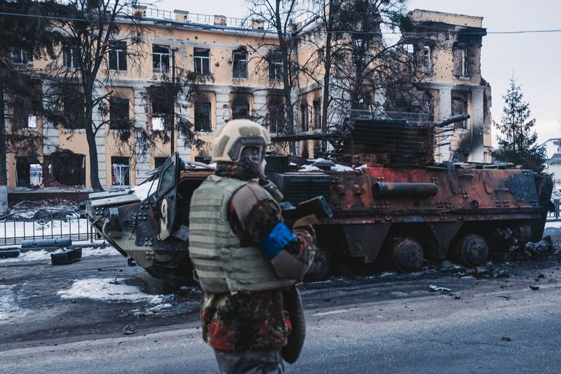 A soldier walks in front of a destroyed Russian tank in Kharkiv, Ukraine, on March 14